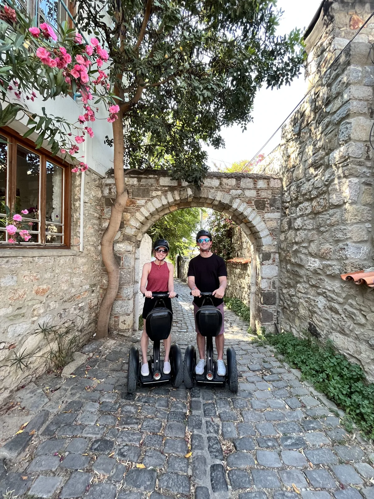 Two people on Segways with marina and castle views